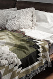 Zio Southwestern Cotton Blend Blanket Throw in Chartreuse, Off-White and Dull Gold, draped over a chair