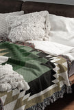 Zio Southwestern Cotton Blend Blanket Throw in Green, Off-White and Dull Gold, draped over a chair