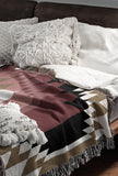 Zio Southwestern Cotton Blend Blanket Throw in Red, Off-White and Dull Gold, draped over a chair
