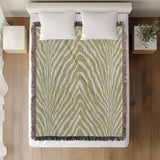 Zoe Animal Print Cotton Blend Blanket Throw in Chartreuse, on a bed