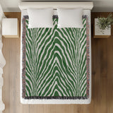 Zoe Animal Print Cotton Blend Blanket Throw in Green, on a bed