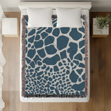 Zuma Animal Print Cotton Blend Blanket Throw in Blue, on a bed
