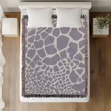 Zuma Animal Print Cotton Blend Blanket Throw in Periwinkle, on a bed