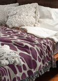 Zuma Animal Print Cotton Blend Blanket Throw in Purple, draped over a chair